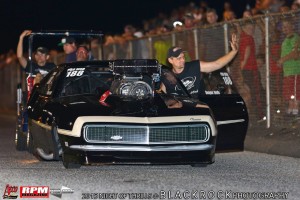 Dwayne Wolfe waves to the enormous crowd on his way back